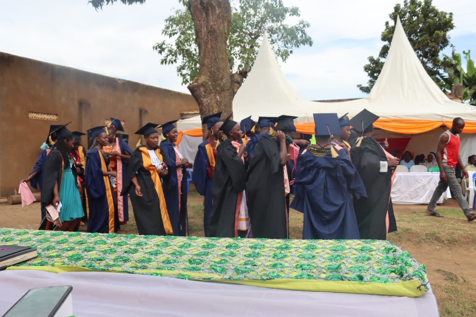 Graduates gathered outdoors after a graduation ceremony.