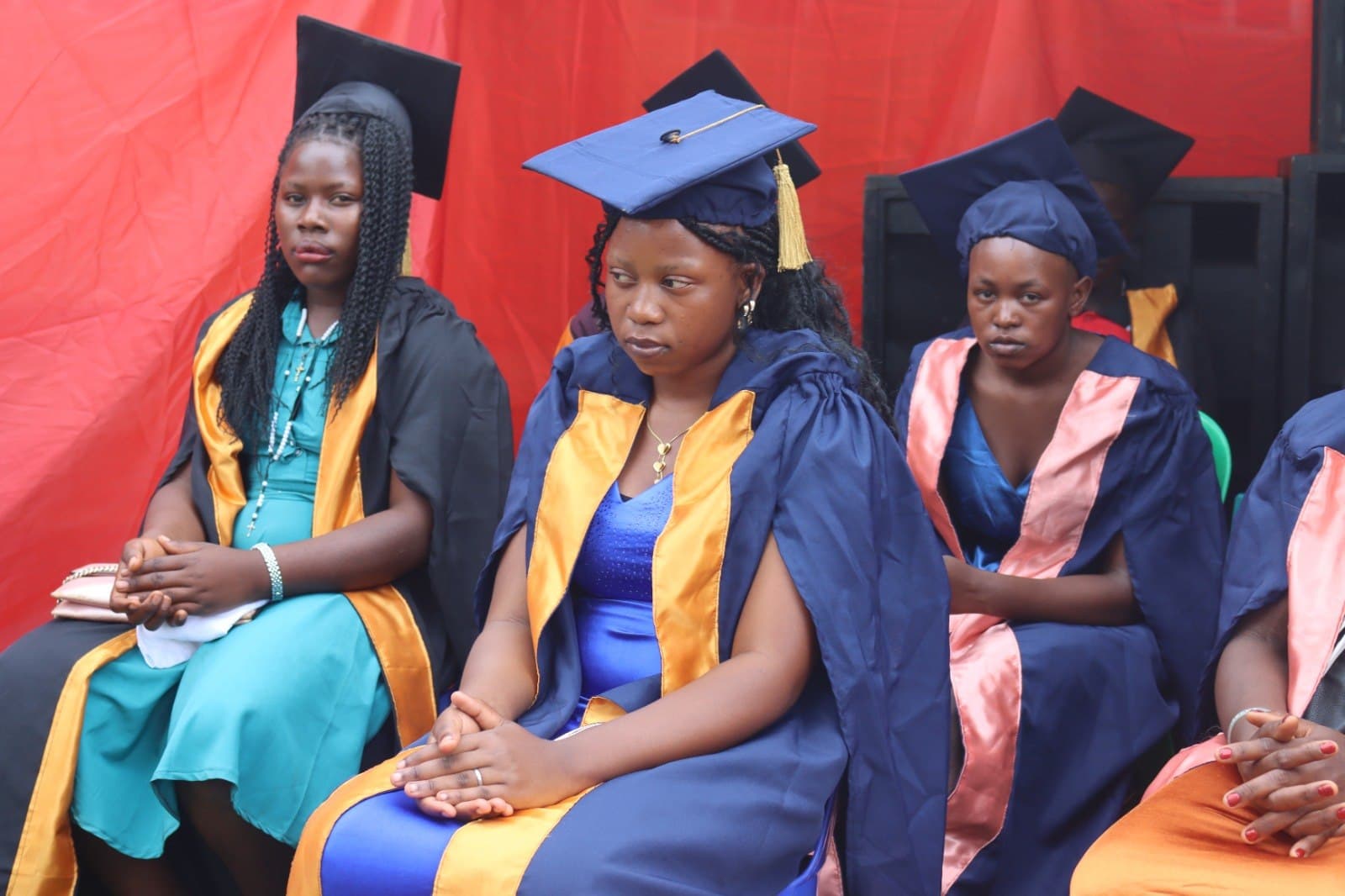 Graduates seated together at a graduation ceremony.